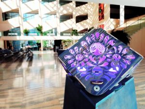 blue wooden lantern with purple lights inside, edmonton city hall inside architecture in the background